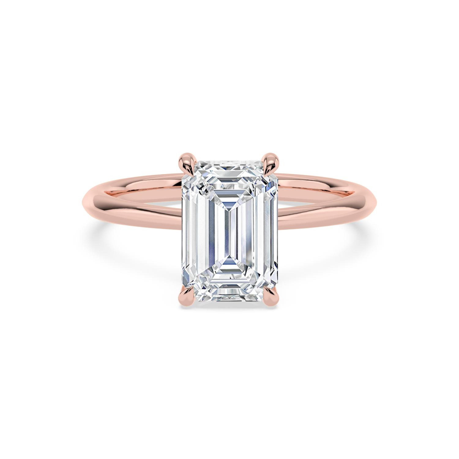 Cairn, Four Prong Emerald Solitaire, Tall Claws, Peek-a-Boo Side Accents in Rose Gold, emerald, plain background